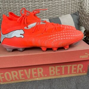 Orange Puma adult men’s soccer shoes